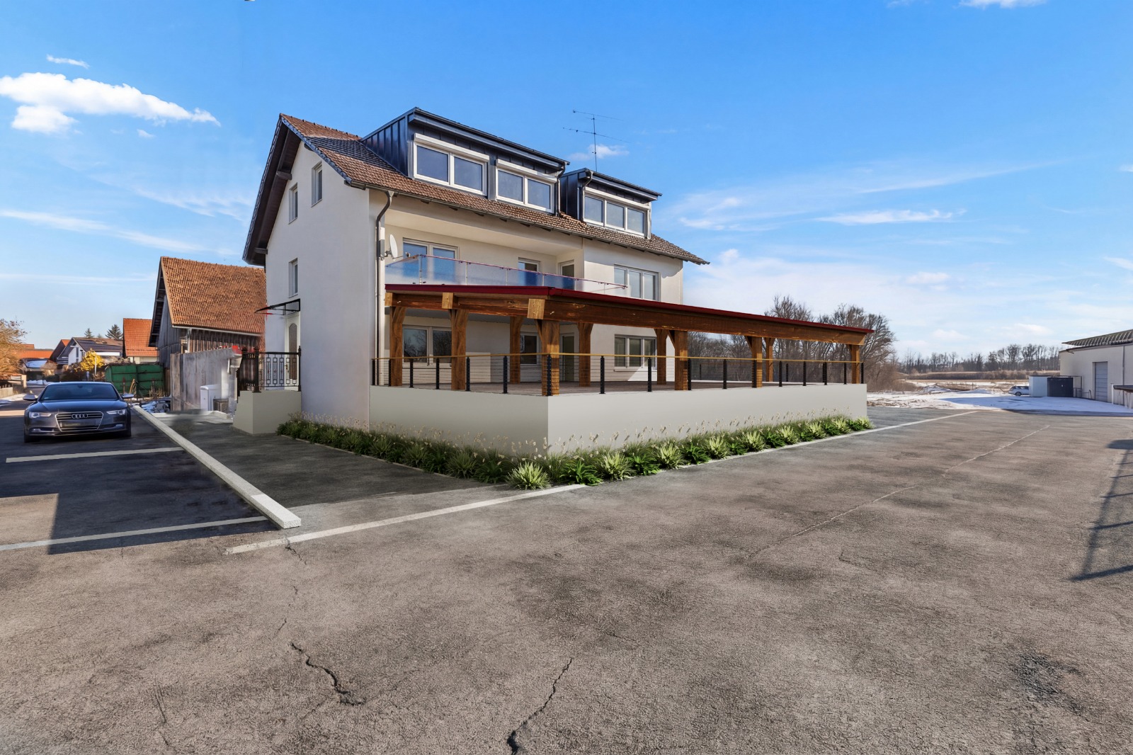 Außenansicht nach Renovierung mit Terrasse und Bepflanzung